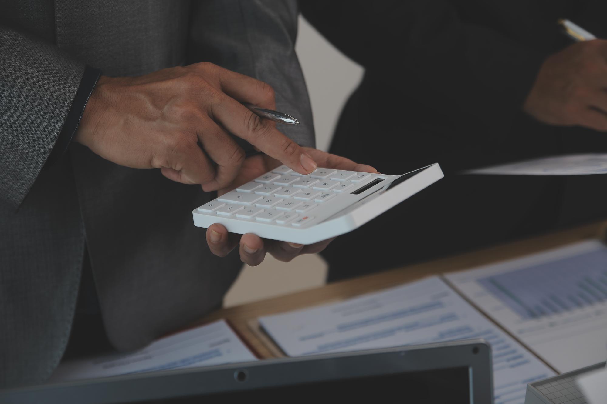 Close-up of hands calculating finance